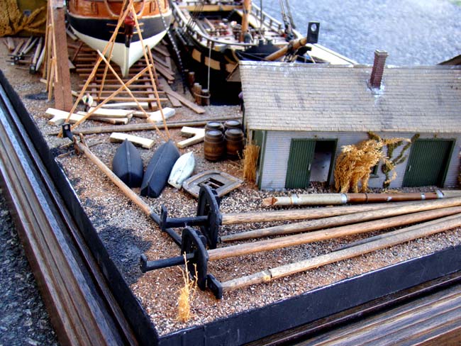 A fabulous and highly detailed scale model diorama circa 1920 of a New England Ship yard circa 1800-1812 making repairs on a 38 Gun American Frigate and a 10 Gun Privateer built circa 1785. — image 10